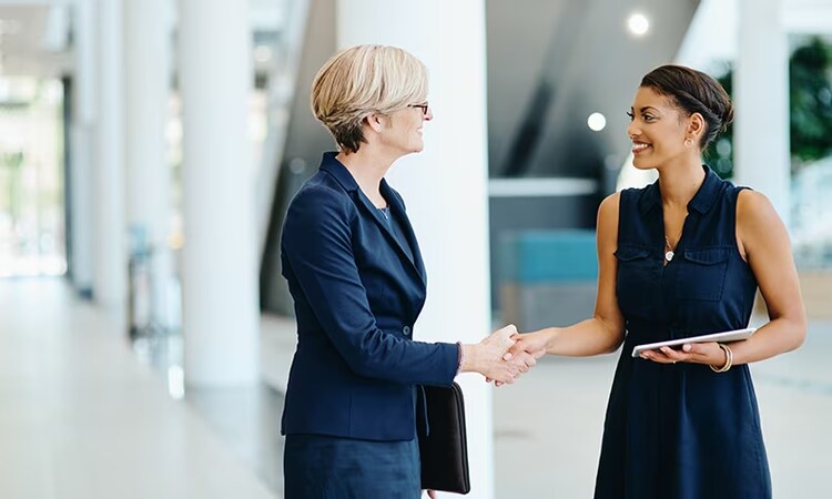 2 women shaking hands
