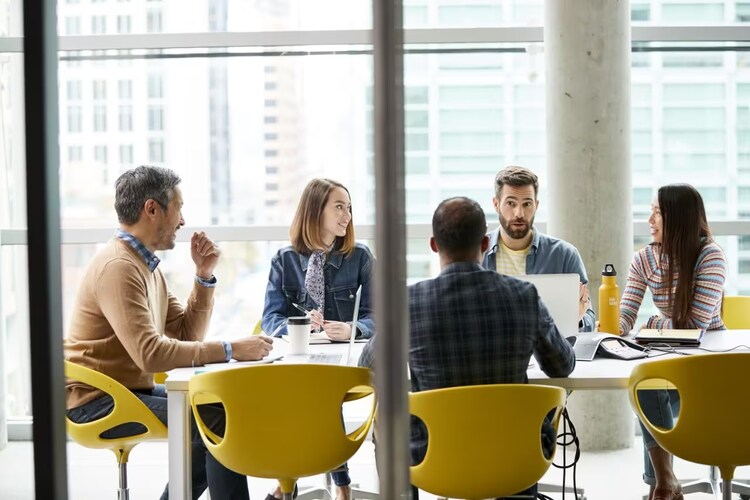 People gathered around a table at a meeting