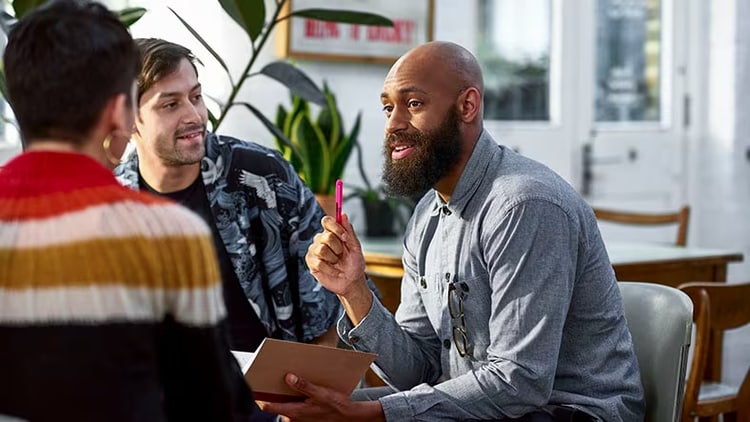 Customer-led innovation: 3 colleagues meet to discuss business.