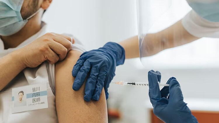 Vaccine validation: A healthcare workers administers a vaccine to a patient.