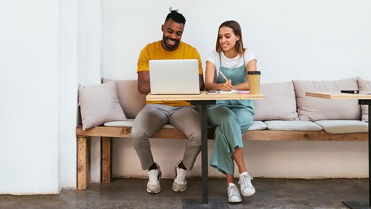 Colleagues working on a laptop together