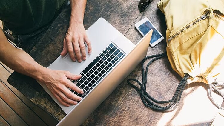 AI search: A person types on a laptop.