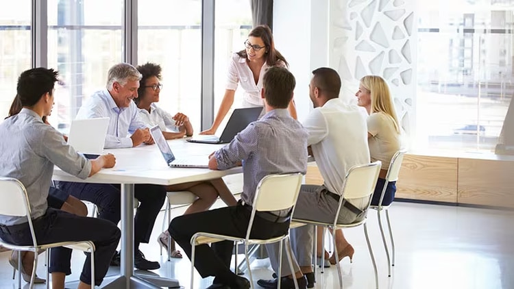 Customer zero: A group of workers collaborate around a conference table.