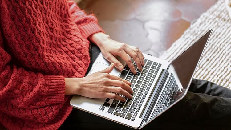 Citizen developers: A woman types on a laptop.