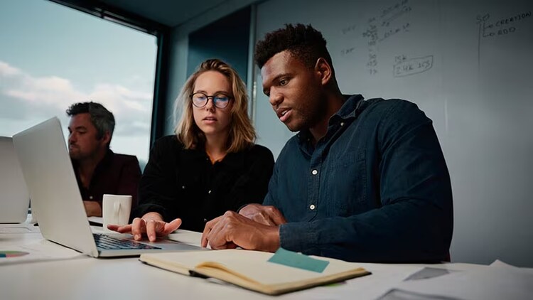 Release upgrade: employees collaborating on work in an office