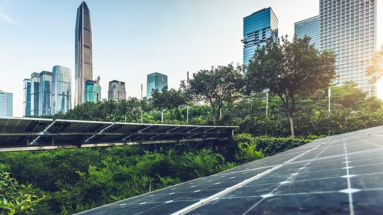 ESG: Solar panels and greenery in the foreground of a cityscape