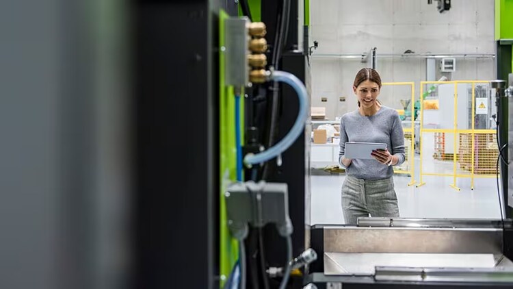 Manufacturing OT: female factory worker looking at machines