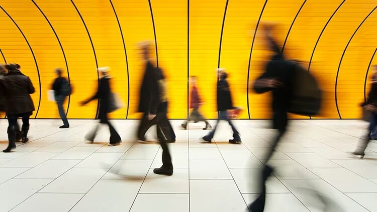 Customer digital transformation: people walking outside against a yellow backdrop