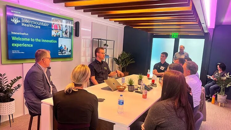 Innovation experiences: A group of workers gathered around a conference table
