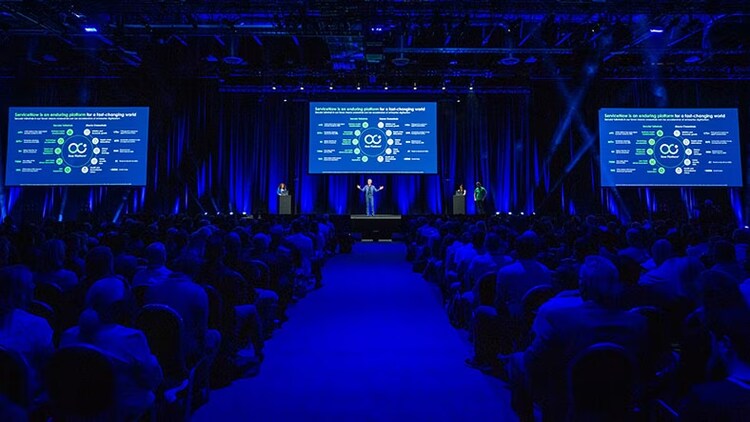 Knowledge keynote recap: indoor venue with ServiceNow CEO Bill McDermott on stage in front of audience
