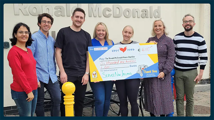 7 ServiceNow employees holding a big check for the Ronald McDonald House