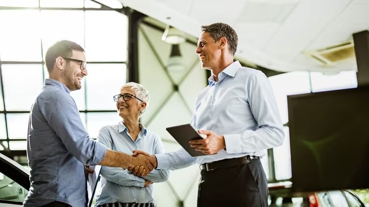 Customer service value chain: 2 men shaking hands while a woman looks on