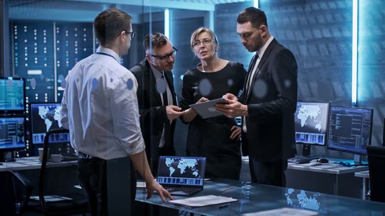 Transformation accelerated: four government workers gathered around a tablet