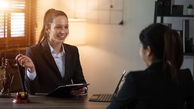 Hidden talent: woman with clipboard smiling at woman on other side of desk
