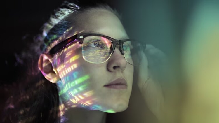 Tech worker myths: young woman in glasses looking at a screen