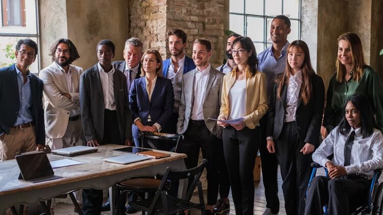 Strategic partnerships: Group of diverse workers gathered in a conference room