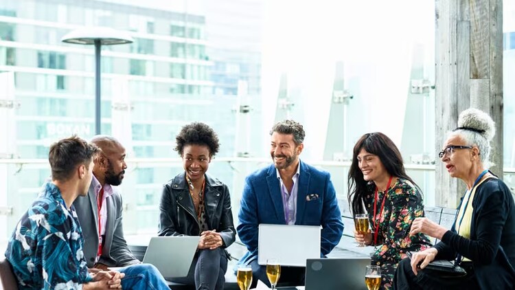 Intelligence in business: group of workers with laptops and smiles