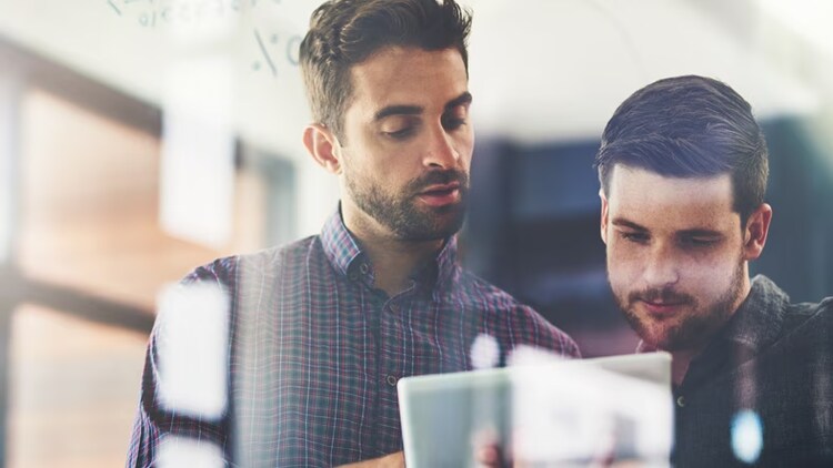 Observability platform: two men looking at a tablet