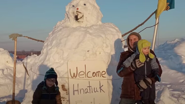 One good reason: Ukrainian refugees in front of a huge snowman