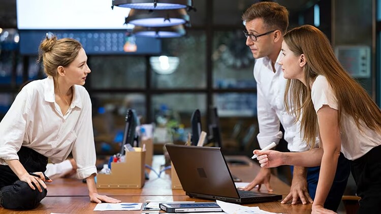 Process mining: 3 workers in discussion over a conference table