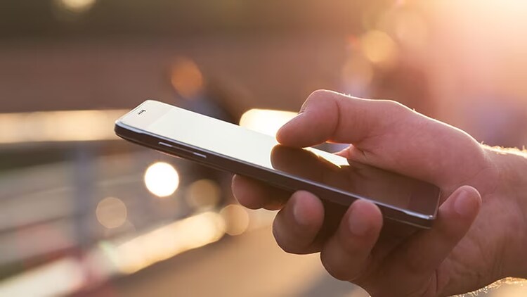 Zero touch mobility: closeup of a hand holding a mobile phone