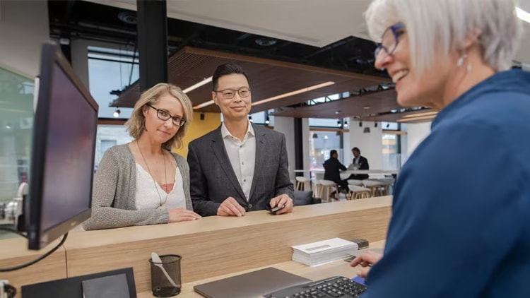 Frictionless banking: Bank teller helping customers