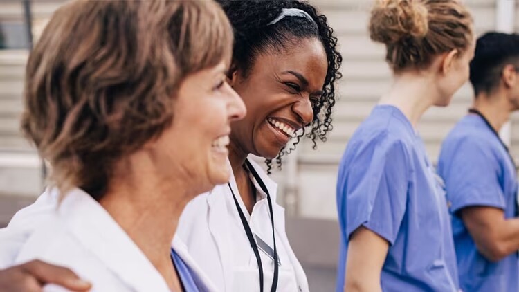 Digital transformation in healthcare for nurse retention: smiling nurses walking