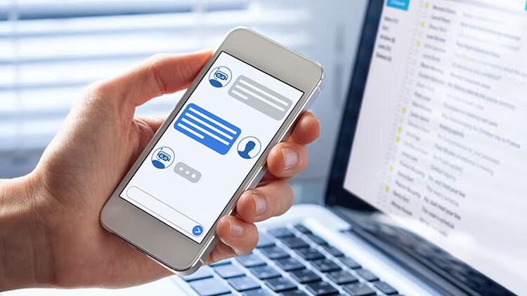 AI-powered chatbots: A hand holds a mobile phone with an AI chatbot conversation displayed.