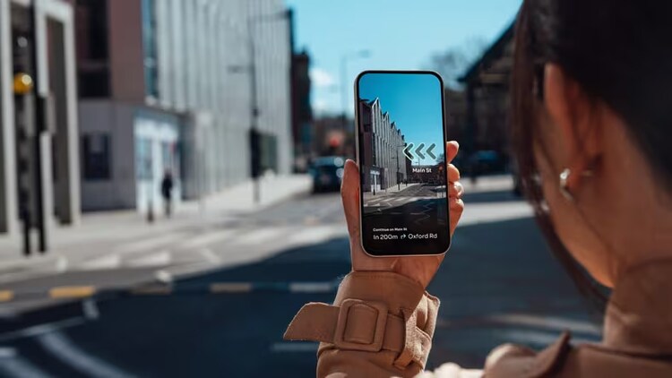 Promise of innovation: phone in foreground showing real-time picture of city in background