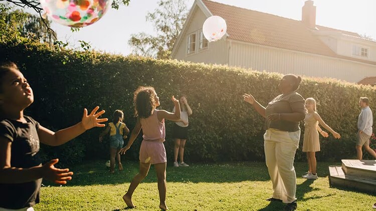 Racial equity fund: multiracial adults and children playing in a backyard