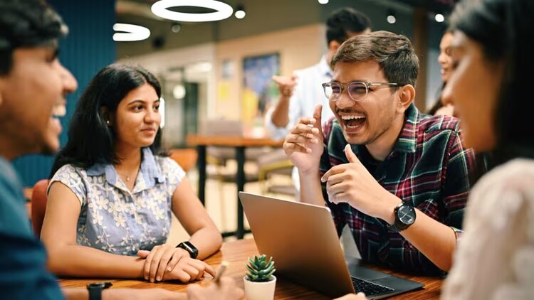 Job growth: 4 Indian workers in conversation around a table