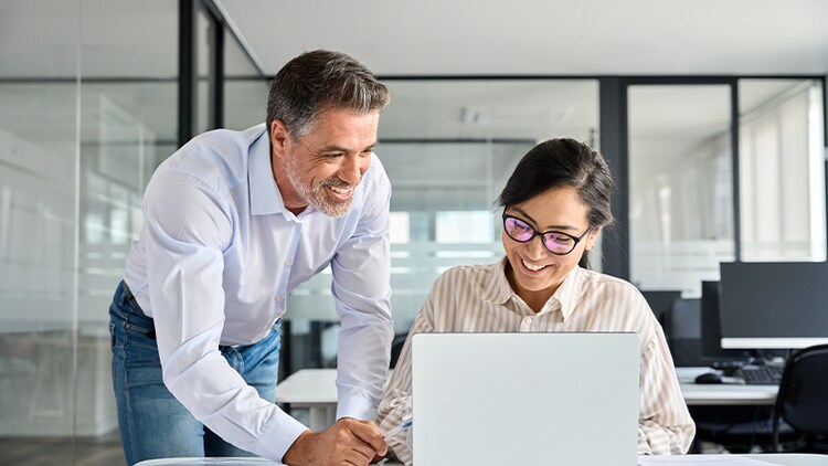 Partner marketing: two office workers looking at a laptop