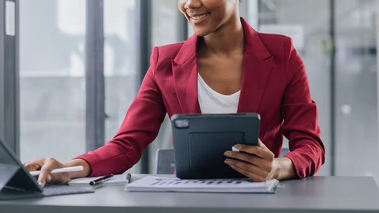 ServiceNow in AWS Marketplace: woman at a desk using devices