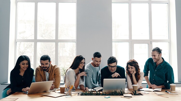 Seven workers engaged in employee development at a conference table