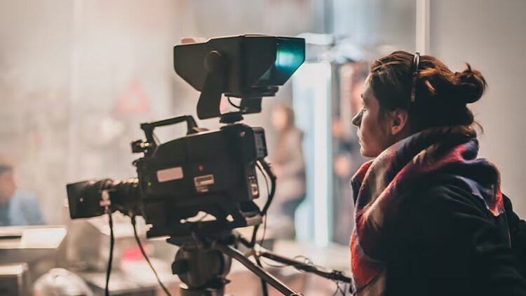 Media solutions: professional camera operator at a press conference