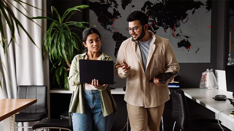 Two employees addressing business problems in an office