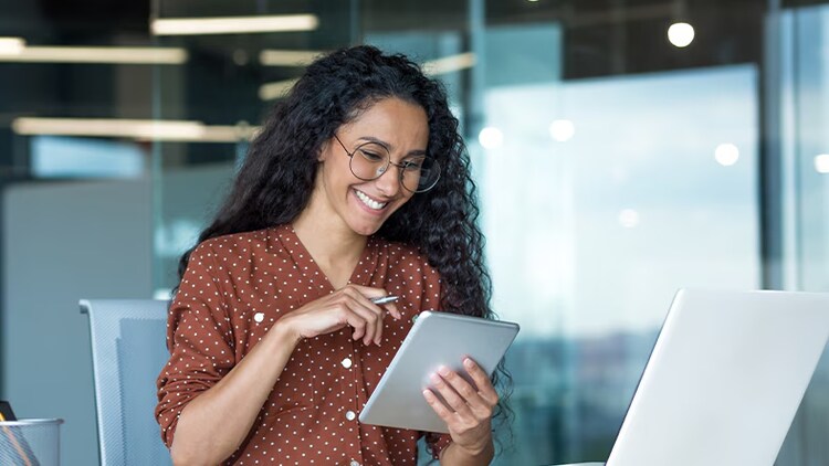 Cloud transformation: woman using tablet and laptop in an office