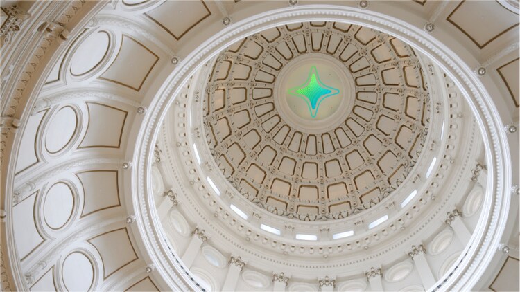 The ceiling of a domed building with a four-pronged star to represent AI in government