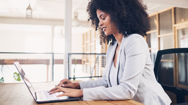 Autonomous HR; woman working on a laptop in a bright office