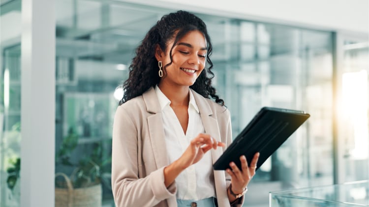 Scale AI: happy woman working on a tablet in a bright office