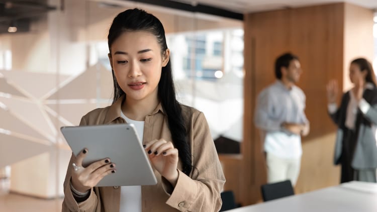 Banking on AI: woman in a corporate office working on a tablet