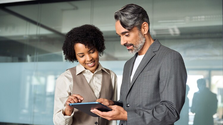 Partner program: two people in an office looking at a tablet together