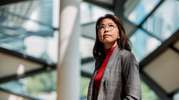 Government services: woman looking up in a modern office building