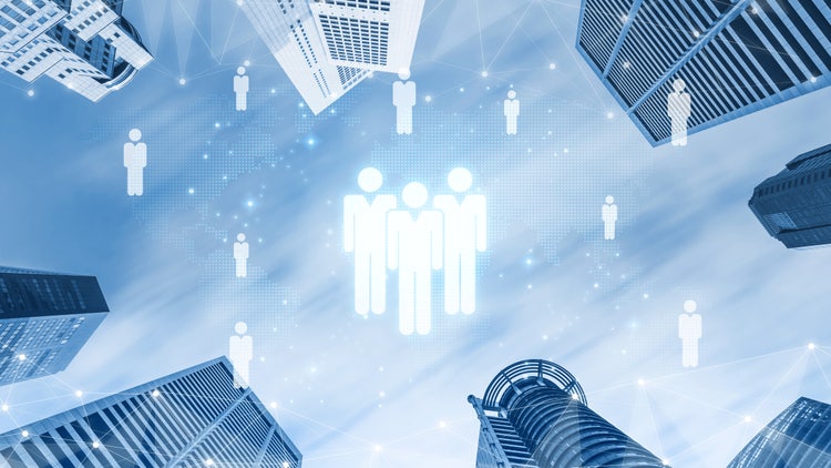 Upward view of a city skyline with glowing person icons