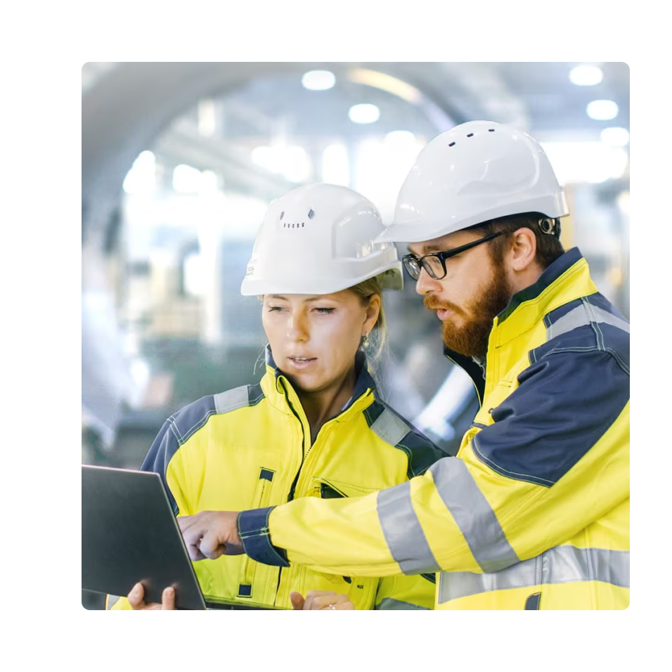 Smart manufacturing workers review plans in factory