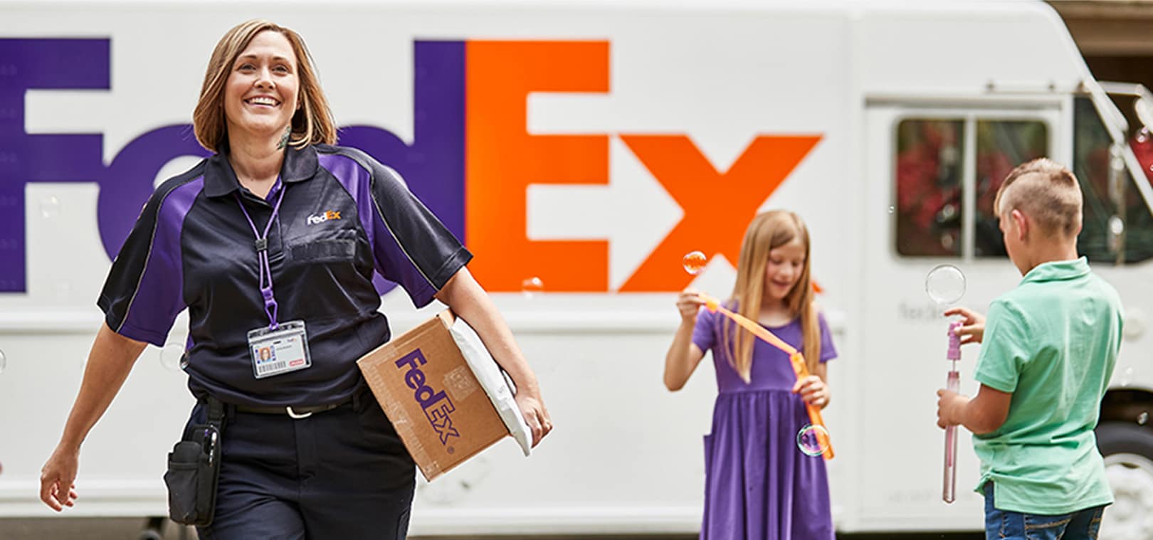 A FedEx employee carries a package at a distribution hub. ServiceNow powers 5 million workflows per month, keeping FedEx's global operations moving at full speed.