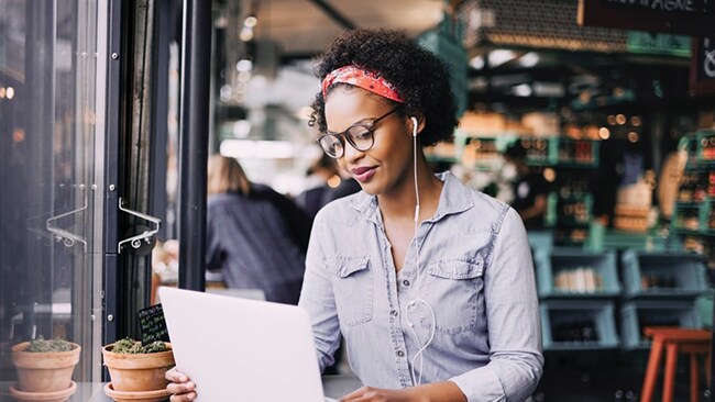 Woman working online on a laptop in a coffee shop