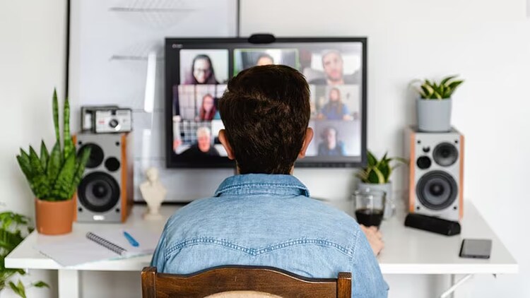 Hybrid work: A worker has a video call with team members.