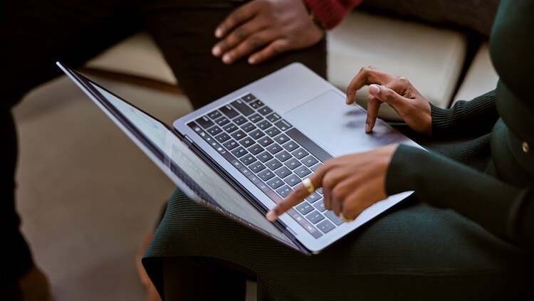 Man sitting on bench with computer