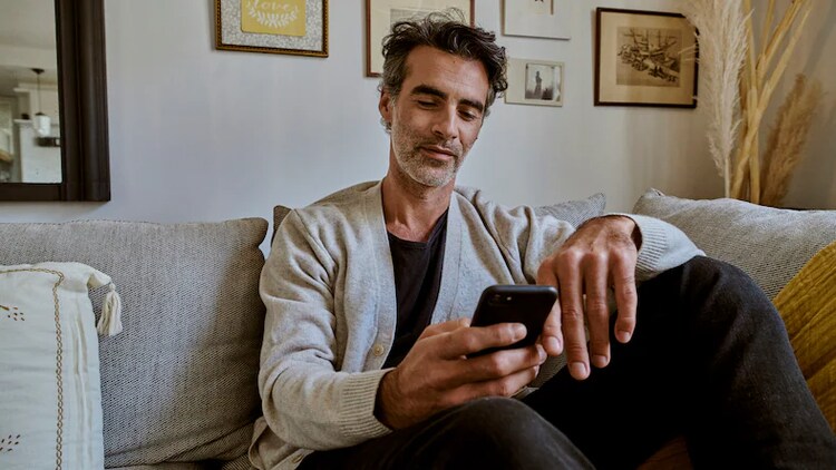 Man sitting on bench with computer